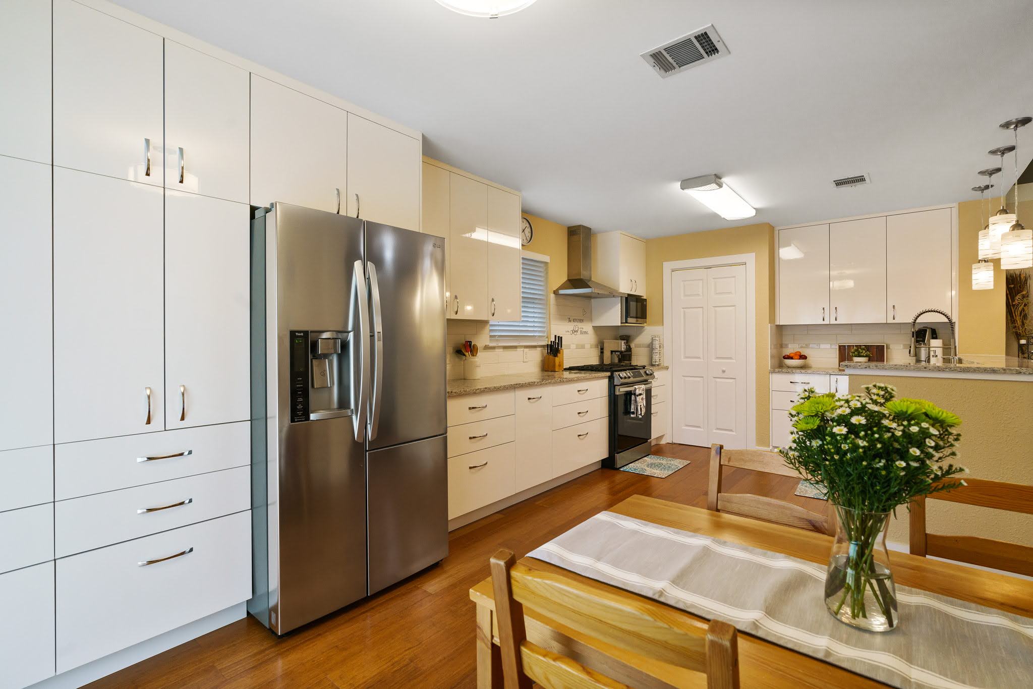 Kitchen remodel with cabinetry, lighting, and countertops